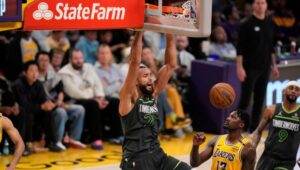 dunks over Los Angeles Lakers forward Dorian Finney-Smith