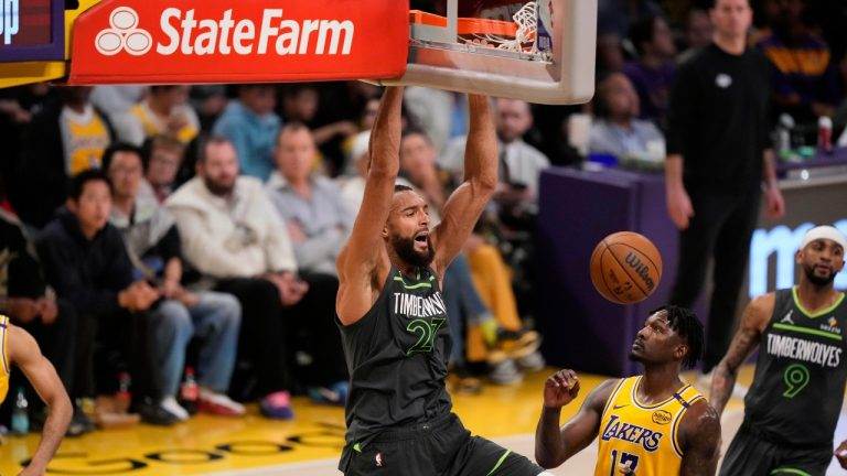 dunks over Los Angeles Lakers forward Dorian Finney-Smith